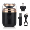 A black portable electric shaver with a gold accent, shown next to its charging cable and replacement head.