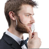 A man is using an all-in-one beard styling template and comb to shape his beard.