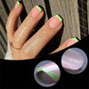 A hand models a set of press-on nails featuring pink, green, and purple colors against a dark background.