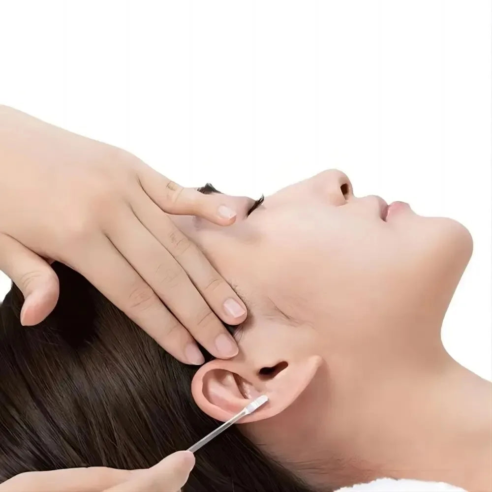 A hand is using a gentle ear wax removal stick to clean an ear.