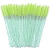 A set of disposable eyelash and eyebrow brushes in bright lime green.