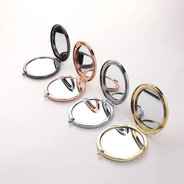 A collection of four portable folding makeup mirrors in silver, rose gold, and gold tones.