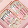 A pink manicure kit featuring a stainless steel nail clipper set with various tools and storage compartments.