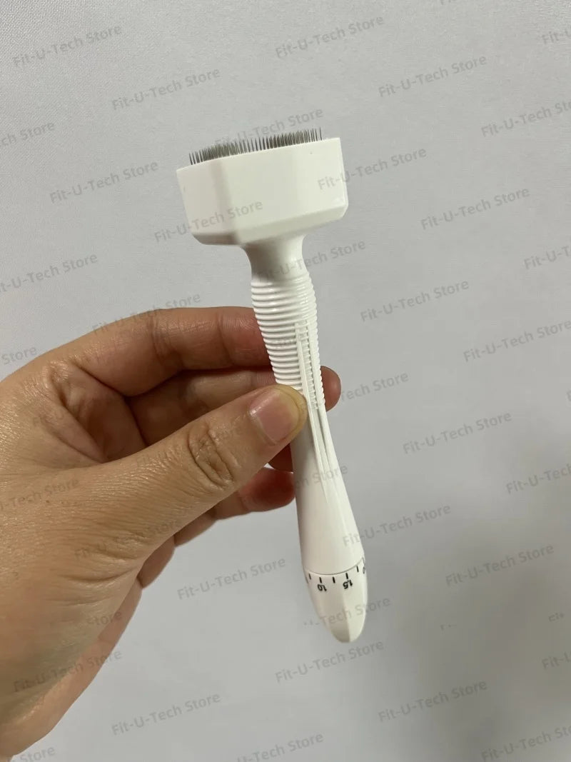 A hand holds a white adjustable microneedling derma stamp device with a fine brush head.