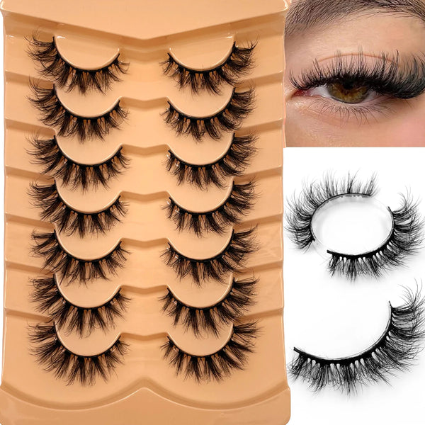A set of dramatic 3D mink fur fake eyelashes displayed on a cosmetic palette and close-up view.