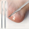 A pair of stainless steel multi-piece foot care tools used for callus and dead skin removal on a foot.