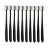 A set of ten ultra-fine bristle toothbrushes in black and white packaging.