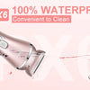 Close-up view of a pink multi-functional electric hair and body groomer with waterproof certification.