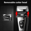 Close-up view of a black electric shaver with a removable cutter head and a rechargeable battery.