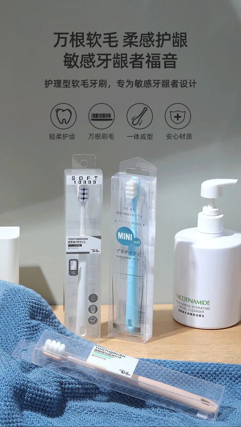 A set of soft bristles toothbrushes packaged in clear plastic and displayed on a blue towel.