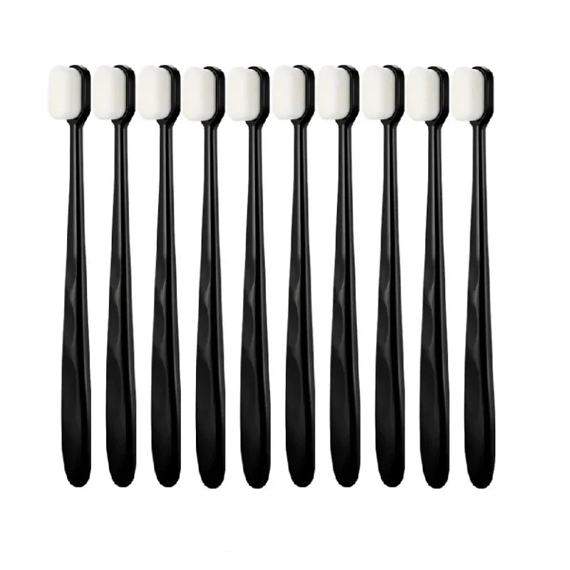 A set of ten ultra-fine bristle toothbrushes in black and white packaging.