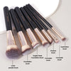 A set of seven professional makeup brushes including eyeshadow, foundation, concealer, and powder brushes.