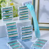 A turquoise precision safety razor with six layers of stainless steel blades is displayed in a clear plastic case.