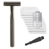 A weighted metal safety razor with a black handle and ten white blade refills stacked next to a single replacement blade.