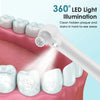 A white electric dental tooth polisher illuminates teeth inside a mouth for cleaning plaque and stains.