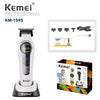 A white Kemei professional cordless hair clipper and trimmer set with a black battery and charging cable.