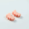 Two pink silicone toe separators designed for foot and bunion relief.