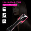 A black 2-in-1 hot air comb hair dryer is shown in a close-up against a dark background.