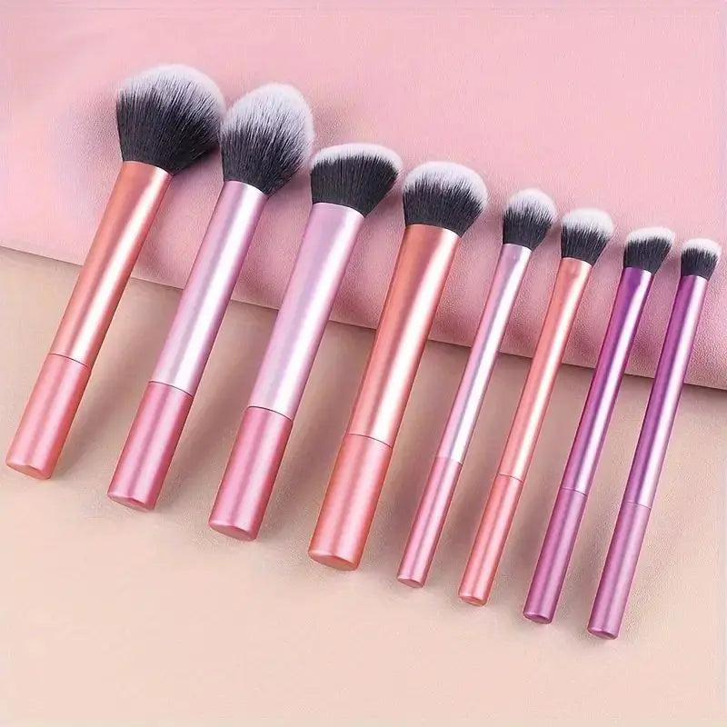 A set of eight pink and purple makeup brushes displayed on a light background.