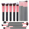 A set of professional makeup brushes in various sizes and shades, including pink and black handles.