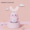 A pink cartoon-designed electric U-shaped toothbrush for children displayed on a stand against a light pink wall.