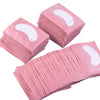 A stack of pink under-eye lash application patches.