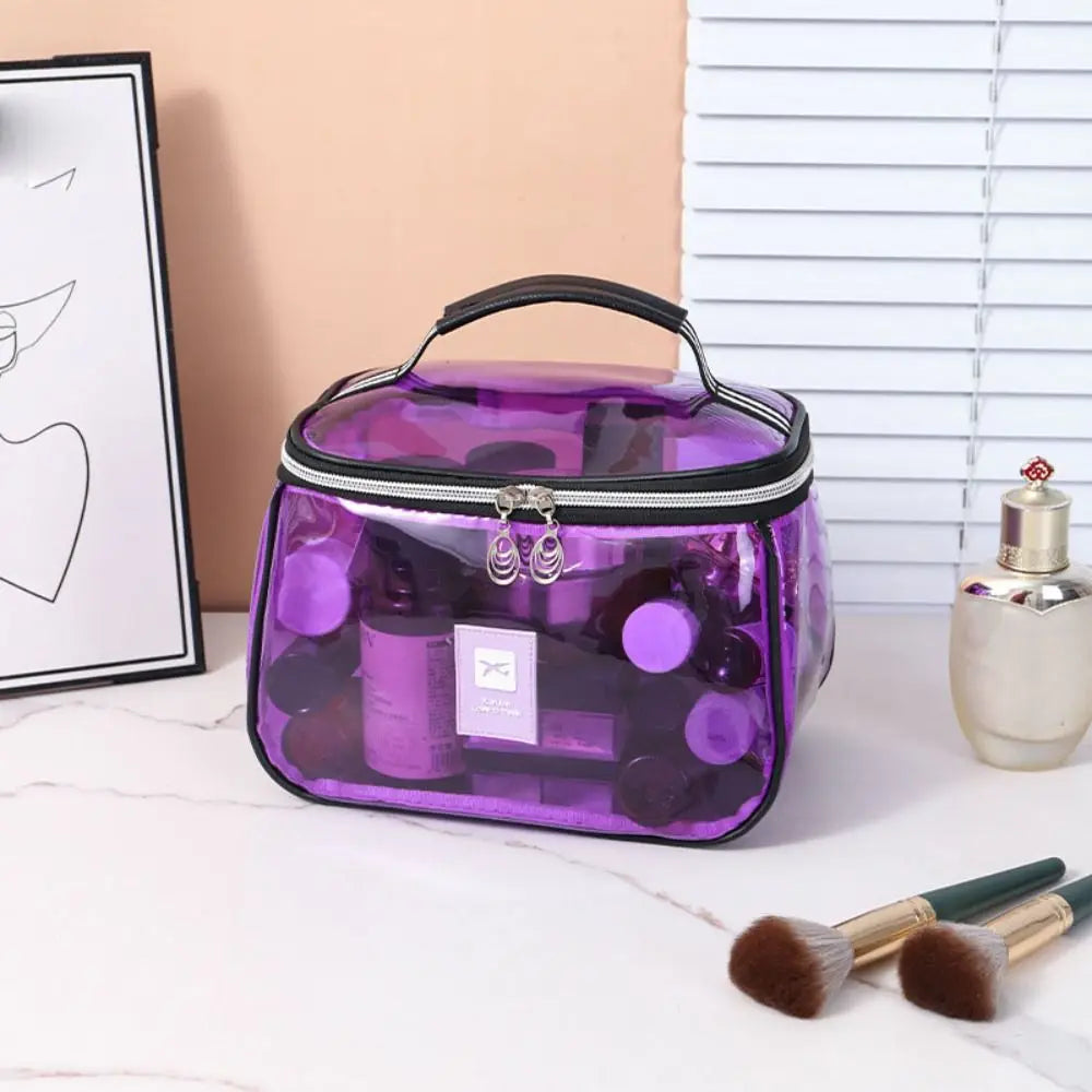 A purple clear PVC cosmetic bag with a black handle and zipper, resting on a white surface.