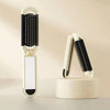 A white folding pocket hair comb with a mirror and scalp massage cushion displayed on a light surface.