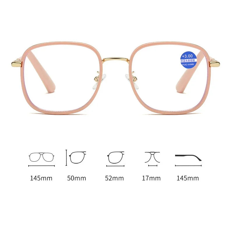 A pair of pink-framed oversized square reading glasses with gold accents and blue light protection features.