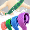 A collection of silicone dual-sided body scrub and exfoliating brushes in various colors, including green, blue, pink, and pu