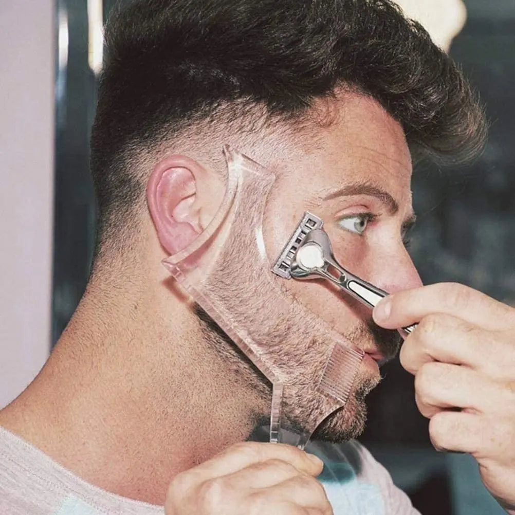 A man is using a beard styling stencil comb on his face to shape his beard.