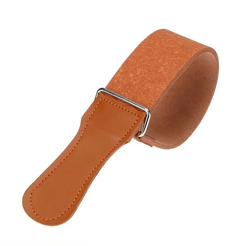 A brown leather sharpening strop with a metal attachment for a straight razor.
