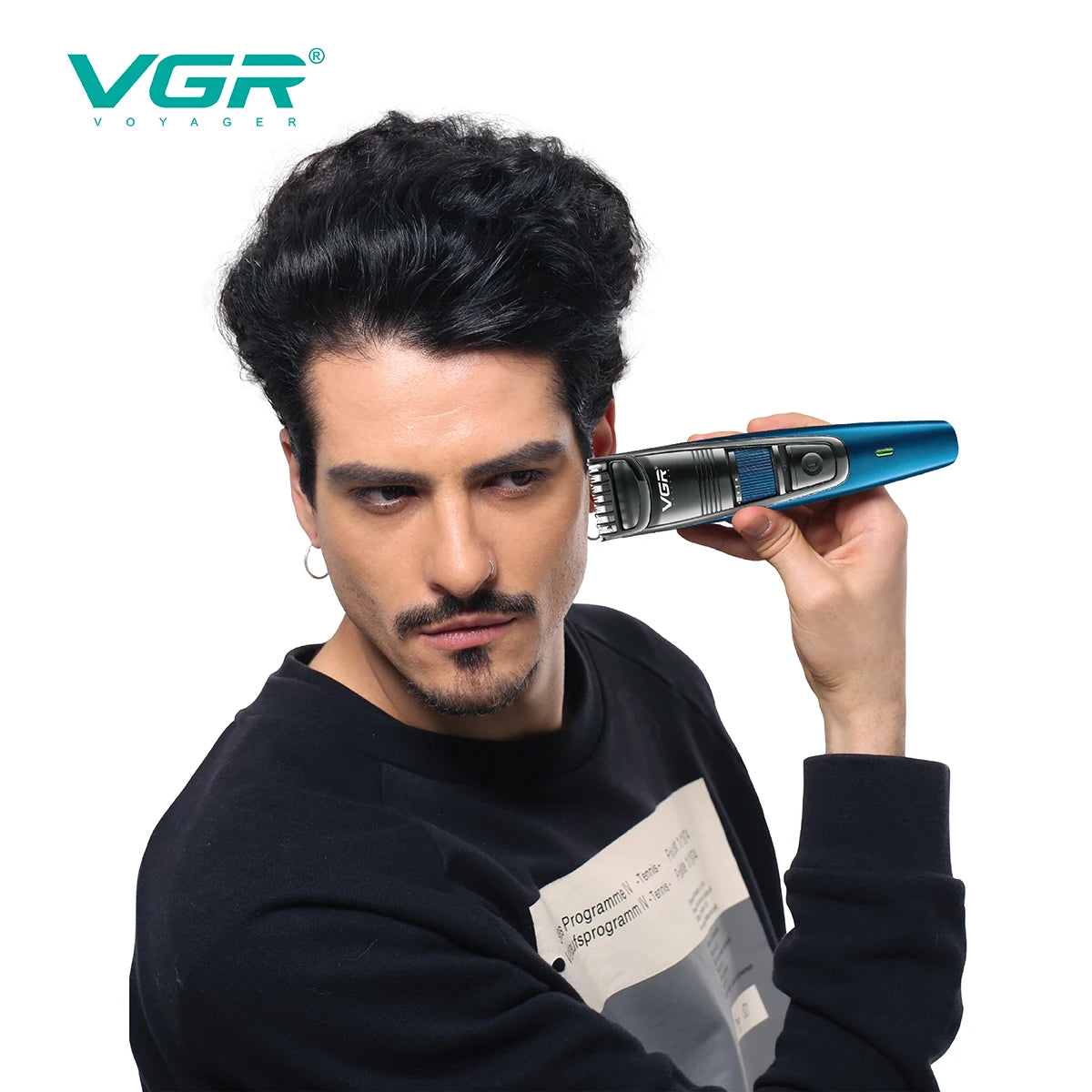 A man is holding a blue VGR electric beard and hair trimmer device up to his face.