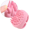 A pink scalp massager shampoo brush with soft silicone bristles shown in a close-up view.