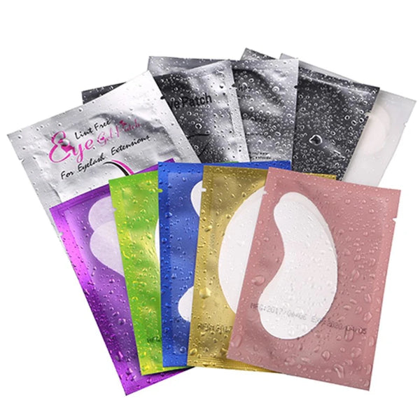 A collection of under-eye lash application patches in various colors including pink, purple, green, blue, and gold.