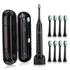 Set de cepillos de dientes sónicos eléctricos negros con múltiples cabezales y base de carga.