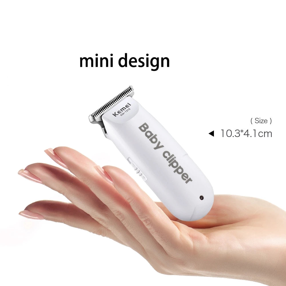 A hand holds a white mini design baby clipper with a silver trimmer head, demonstrating its size.