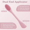 A pink dual-end silicone applicator brush showing the brush end and spatula end for face cleansing.