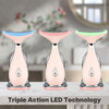 Three pink LED photon therapy massagers displayed on a white table.