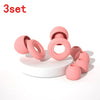 A set of three pink silicone ear plugs shown on a white surface.