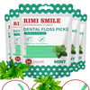 Rimsmile dental floss picks in mint flavor shown with loose mint leaves and a portable case.