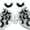 A pair of natural mink striped false eyelash extensions are displayed in an open white cosmetic case.