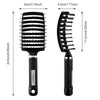 A black curved vented hair brush with a textured surface and a smooth handle.