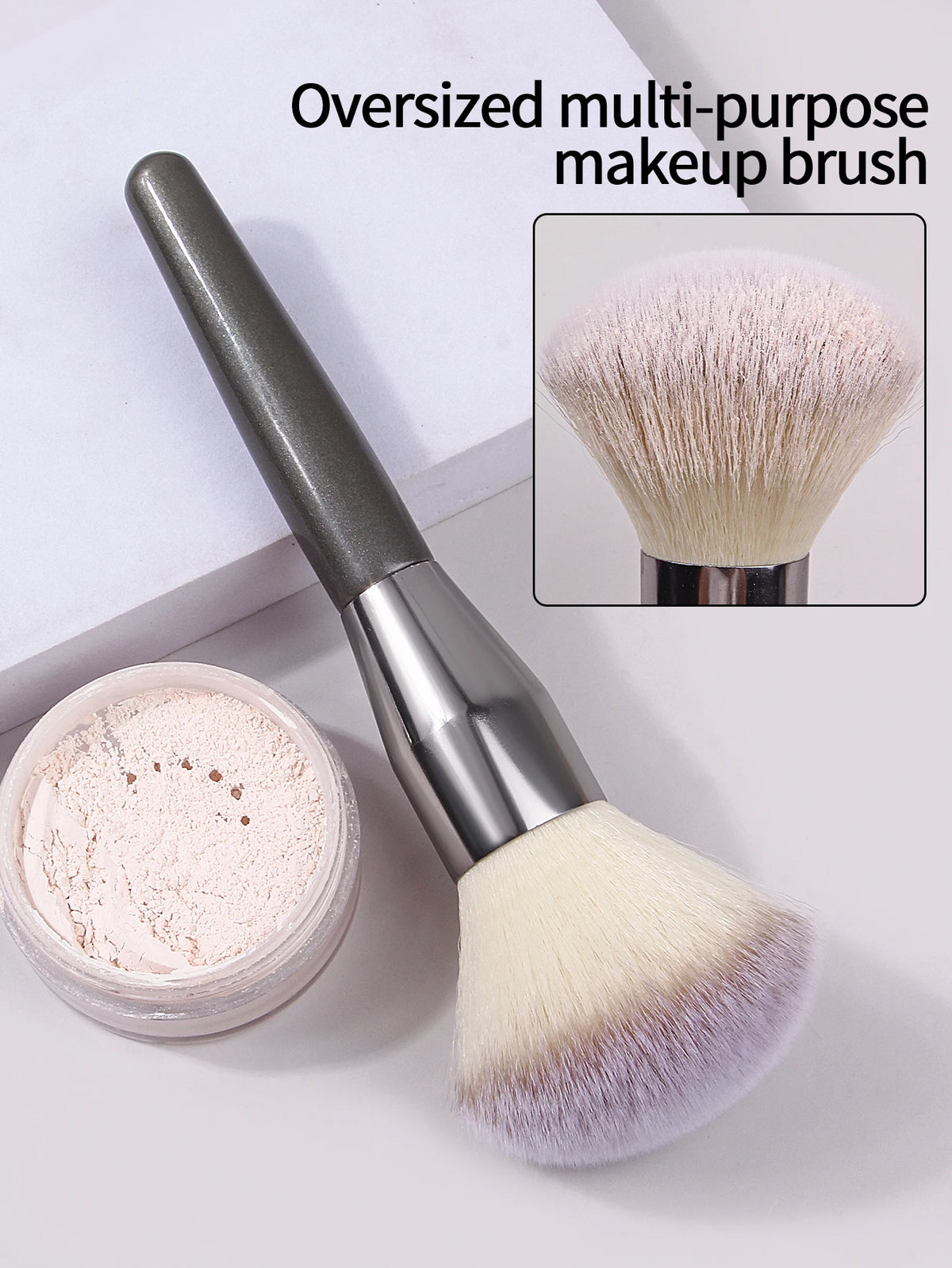 An oversized multi-purpose makeup brush with a silver handle and fluffy pink bristles is shown next to its powder container.