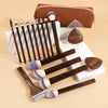 A set of 17 professional makeup brushes in various sizes and colors with a brown travel bag.