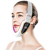 A woman is using a white facial lifting massager with LED photon therapy on her face.