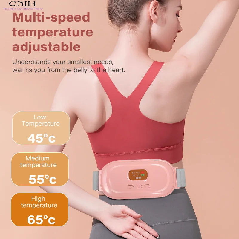 A woman is using a pink multi-speed temperature adjustable heated abdominal massage belt on her torso.