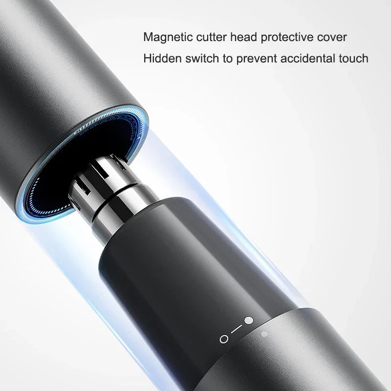 Close-up of a black electric hair trimmer with a magnetic cutter head protective cover and a hidden switch.