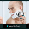 Three images showing a men's electric head shaver in use dry, with foam, and in the shower.
