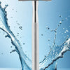 A silver vintage double edge safety razor is shown floating in water with splashing droplets.